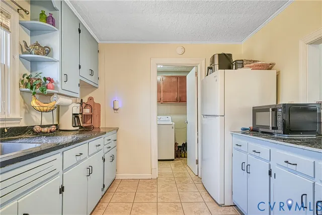 a kitchen with stainless steel appliances a sink cabinets and a counter top space