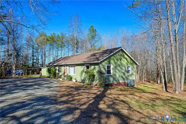 a view of a house with a yard and tree s