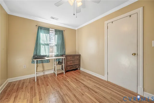 a view of room with window and wooden floor