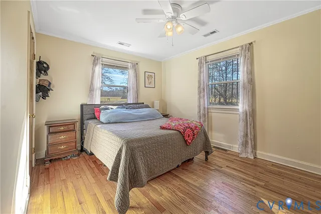 a bedroom with a bed dresser and a window