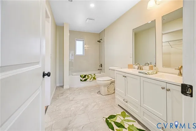 a spacious bathroom with a granite countertop sink mirror and toilet