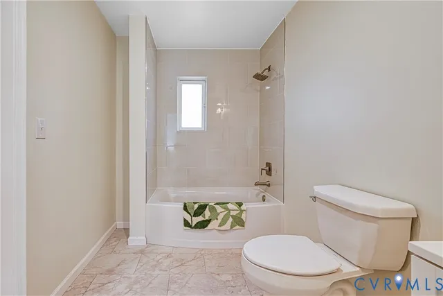 a white toilet sitting next to a bathroom sink