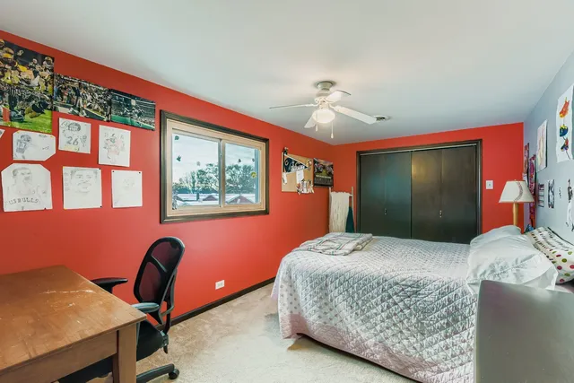 a bedroom with a bed and a desk