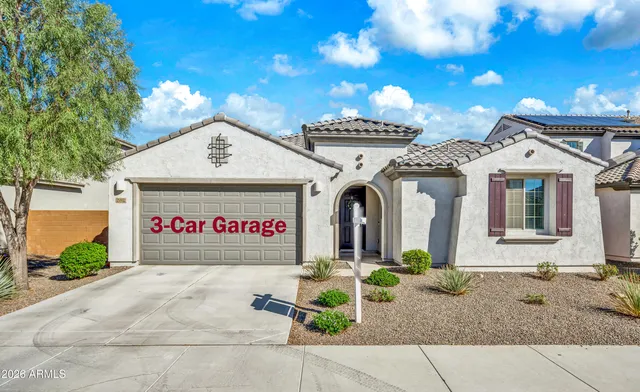 a living room with furniture kitchen view and a chandelier