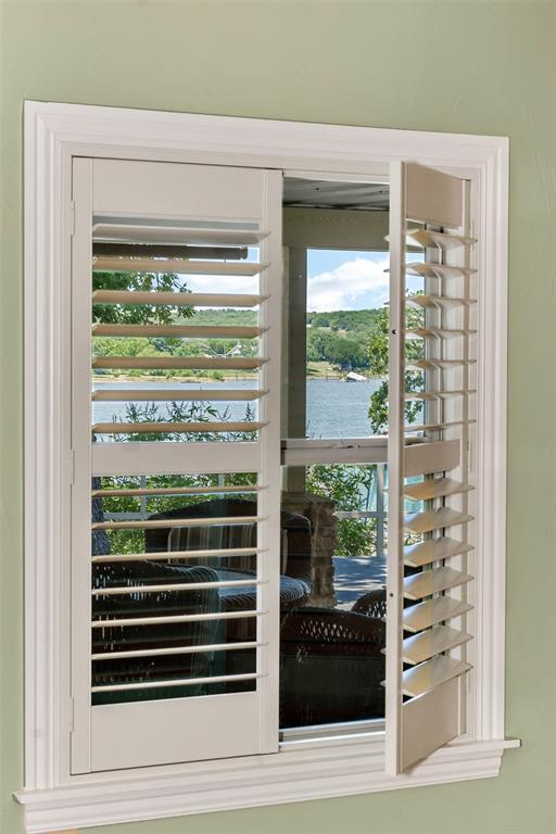 566 Selma Park Road Bowie, TX 76230 - Photo 14 of 40 Window with louvered shutters, white trim, and a serene water backdrop