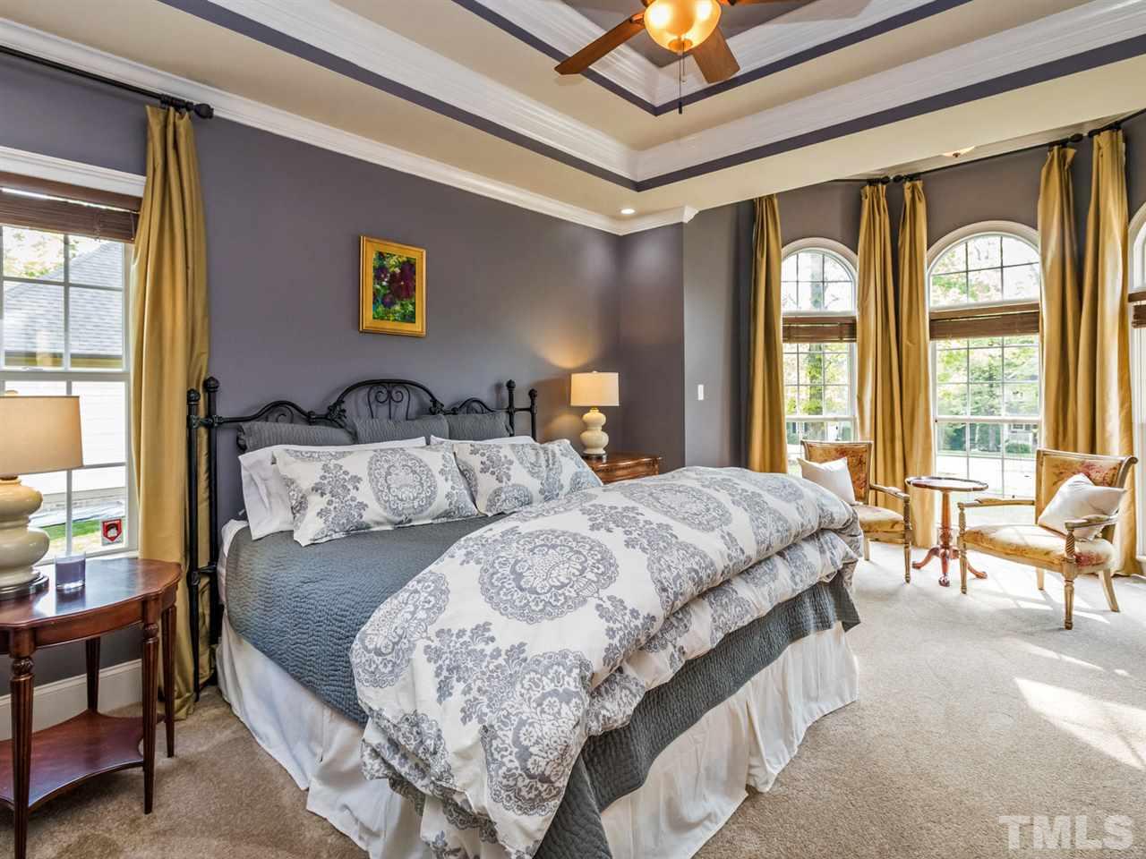 3424 Griffice Mill Road Raleigh, NC 27610 - Photo 11 of 25 a bedroom with a large bed and a large window
