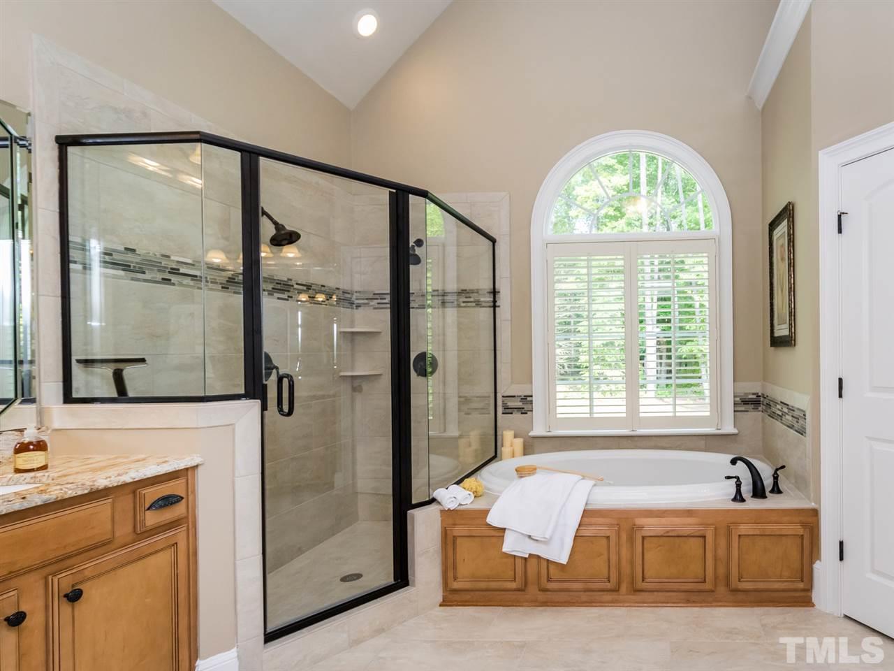 3424 Griffice Mill Road Raleigh, NC 27610 - Photo 12 of 25 a spacious bathroom with a tub mirror and window