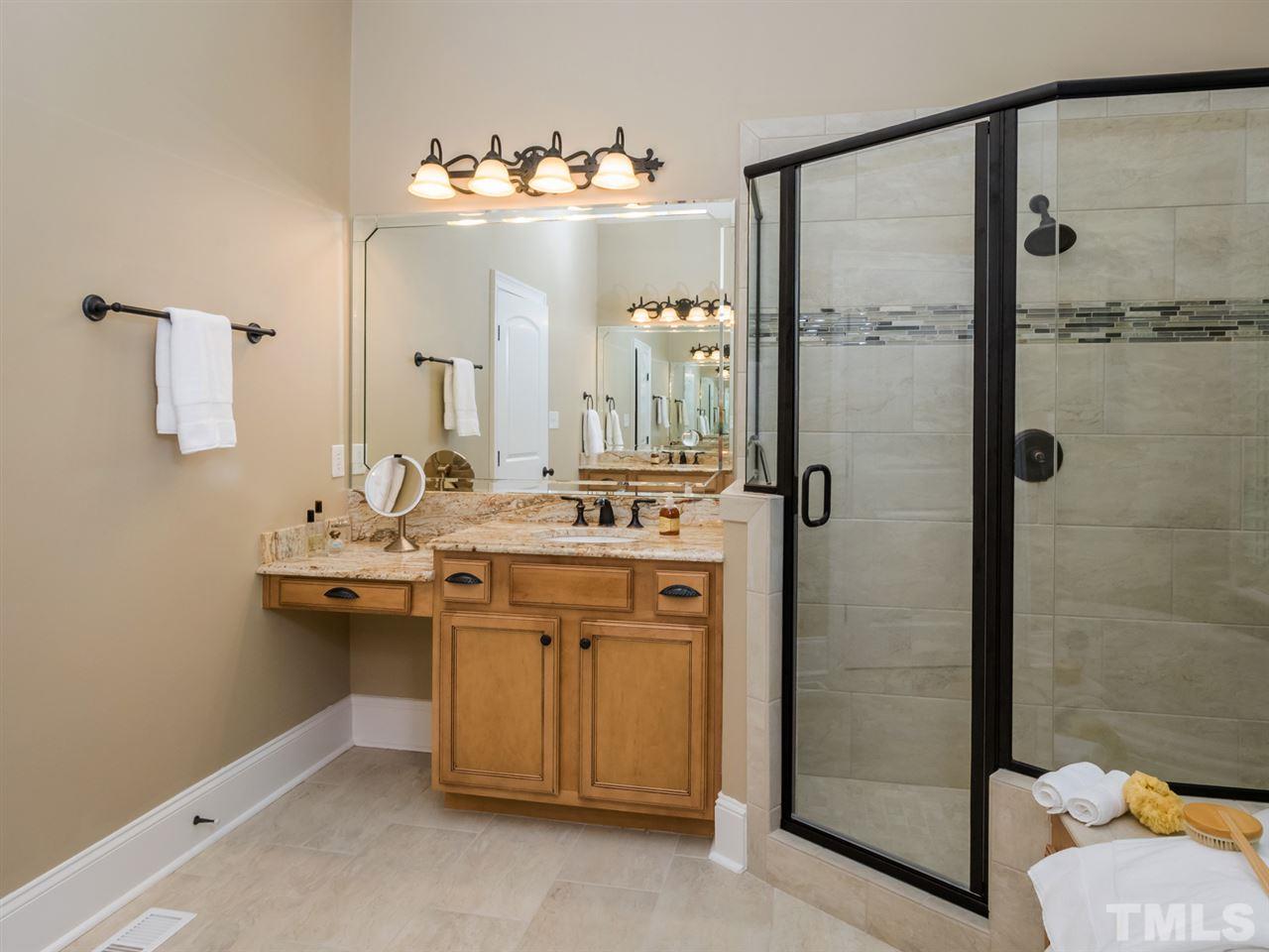 3424 Griffice Mill Road Raleigh, NC 27610 - Photo 13 of 25 a bathroom with a double vanity sink mirror and shower
