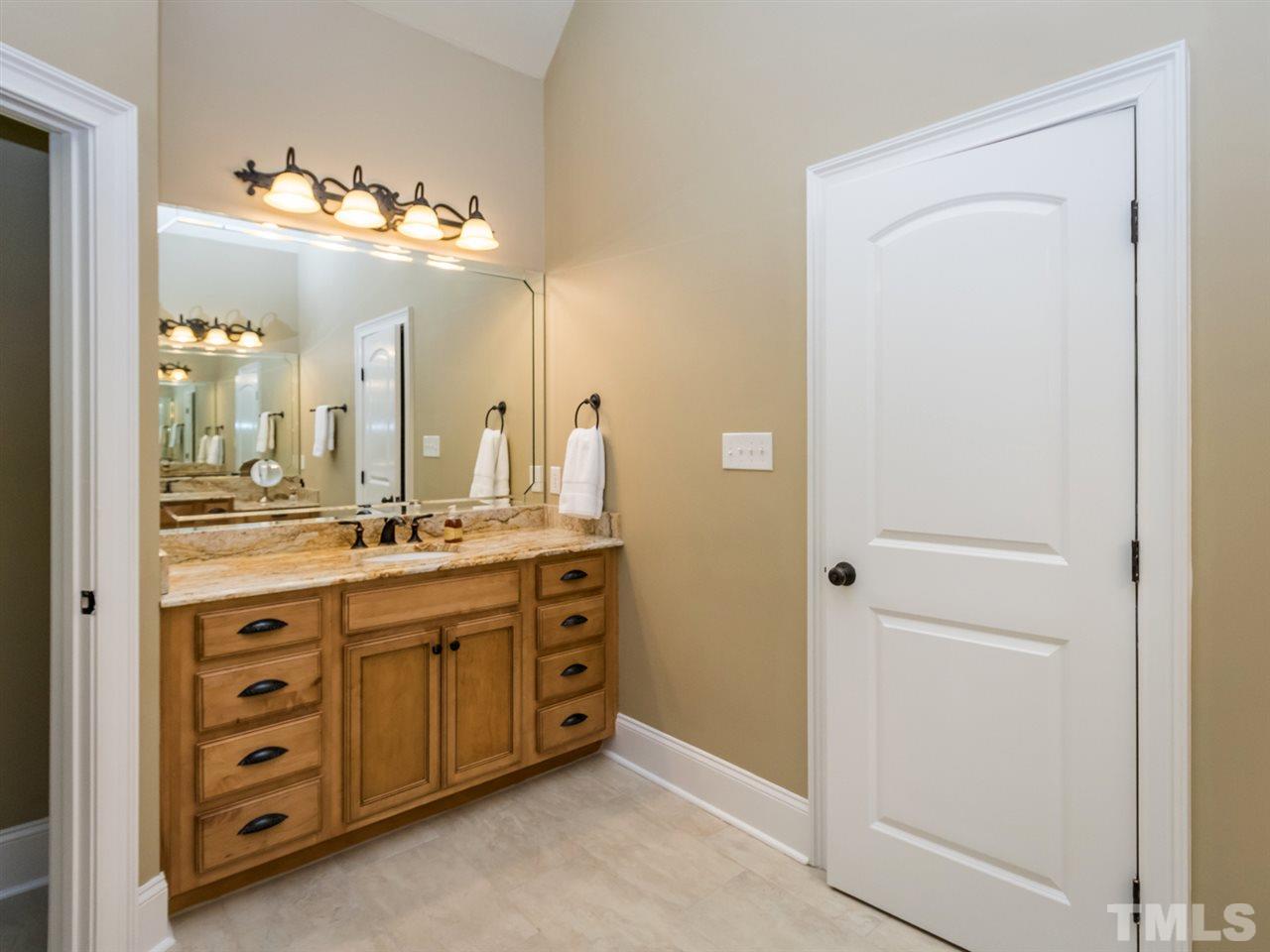 3424 Griffice Mill Road Raleigh, NC 27610 - Photo 14 of 25 a spacious bathroom with a double vanity and a mirror