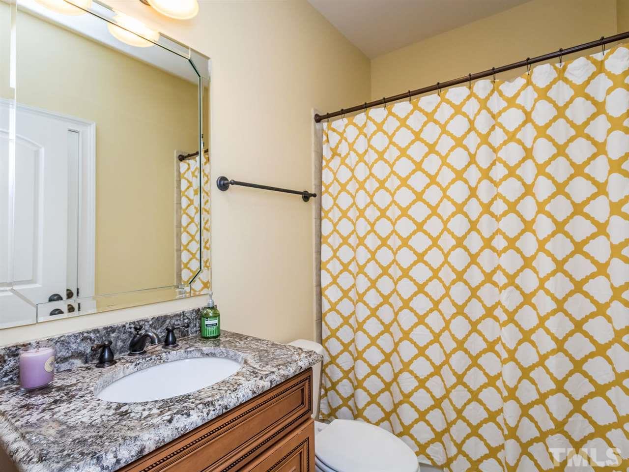 3424 Griffice Mill Road Raleigh, NC 27610 - Photo 16 of 25 a bathroom with a granite countertop sink and a mirror