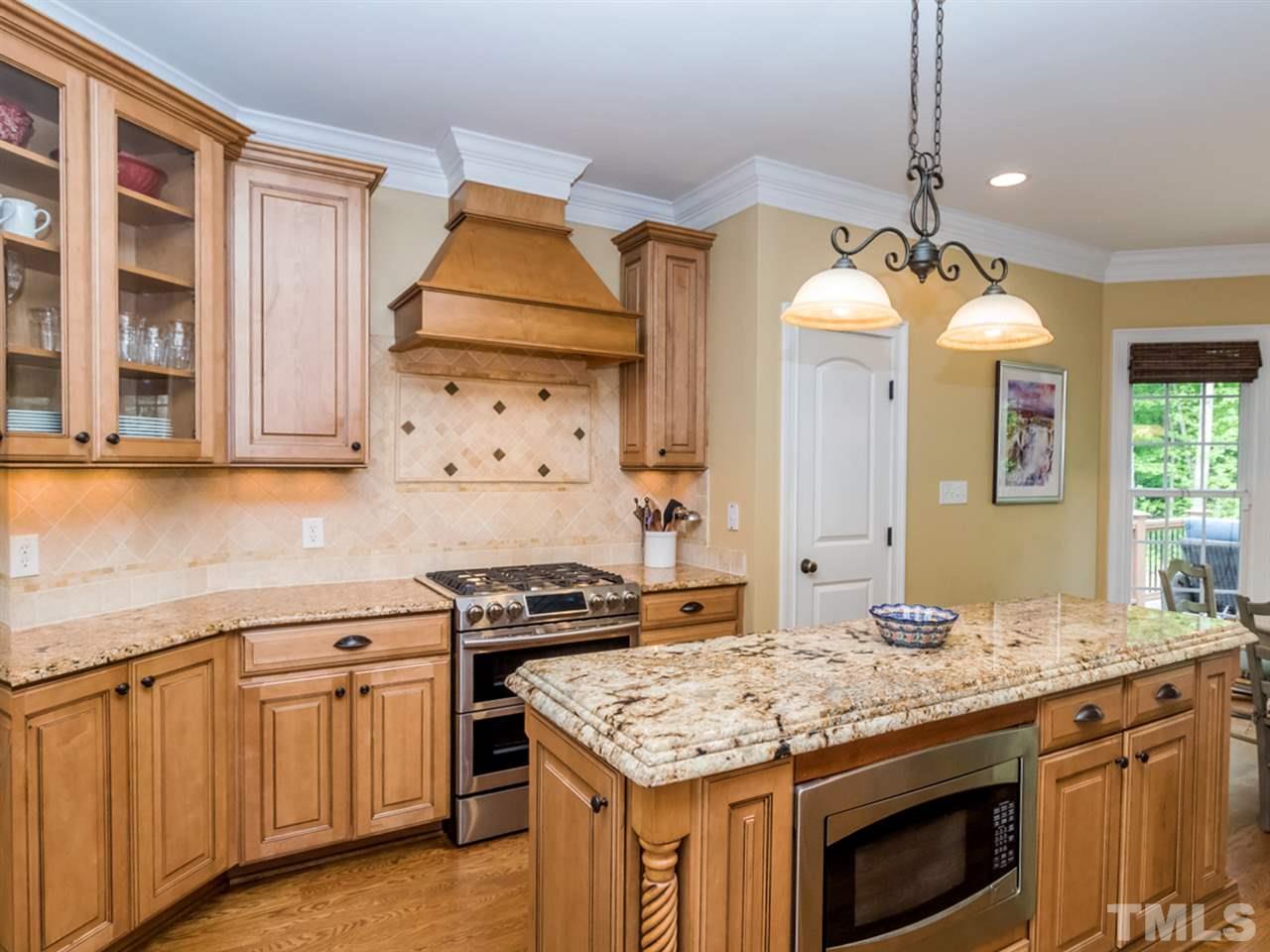 3424 Griffice Mill Road Raleigh, NC 27610 - Photo 7 of 25 a kitchen with granite countertop a sink stove and cabinets