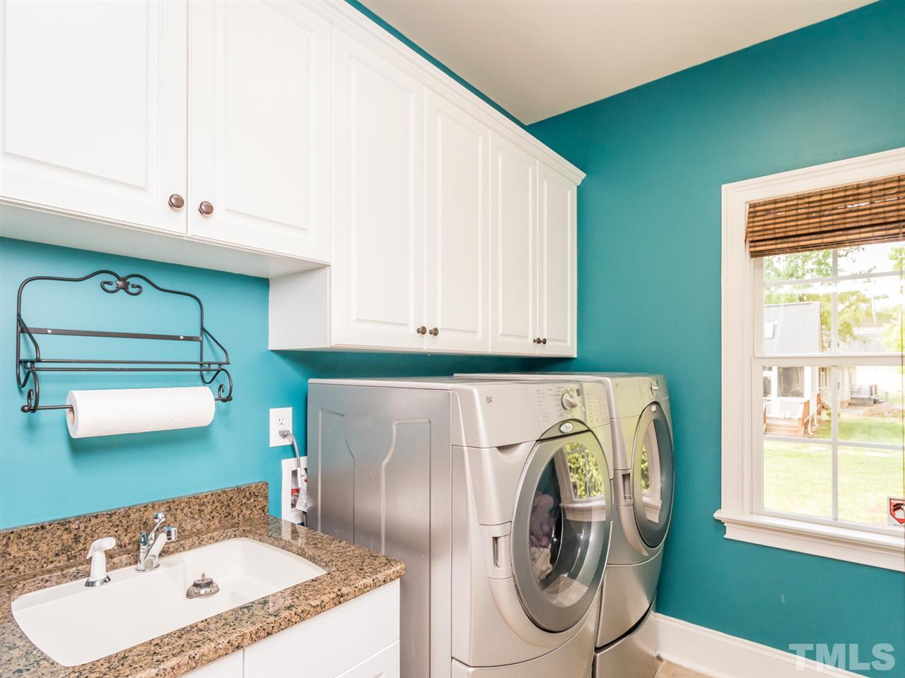 3424 Griffice Mill Road Raleigh, NC 27610 - Photo 10 of 25 a bathroom with a sink a washer and dryer
