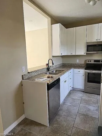 a kitchen with a sink stove and cabinets