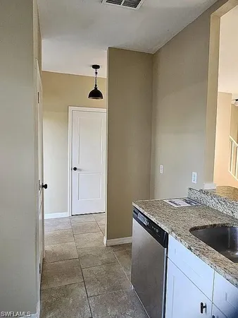 a kitchen with granite countertop a sink and a stove with granite countertops
