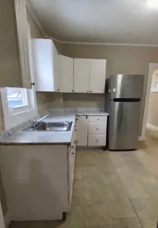 a kitchen with a sink a stove and a refrigerator