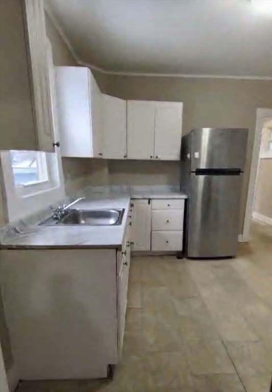 a kitchen with a sink a stove and a refrigerator