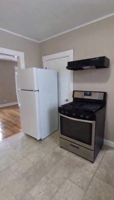 279 Chestnut Street, Unit 2 Lynn, MA 01902 - Photo 11 of 13 a kitchen with a refrigerator and a stove