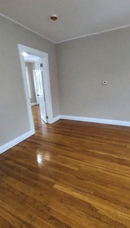 279 Chestnut Street, Unit 2 Lynn, MA 01902 - Photo 13 of 13 a view of empty room with wooden floor