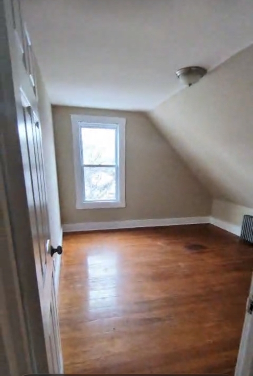 279 Chestnut Street, Unit 2 Lynn, MA 01902 - Photo 4 of 13 an empty room with wooden floor and windows