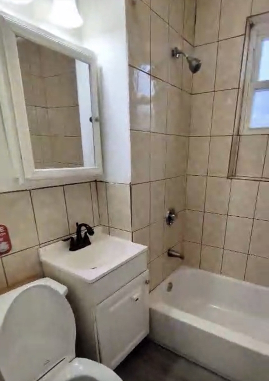 279 Chestnut Street, Unit 2 Lynn, MA 01902 - Photo 9 of 13 a bathroom with a sink and bathtub with shower