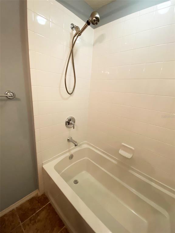 8946 White Sage Loop Lakewood Ranch, FL 34202 - Photo 31 of 36 a bathroom with a bath tub with a shower