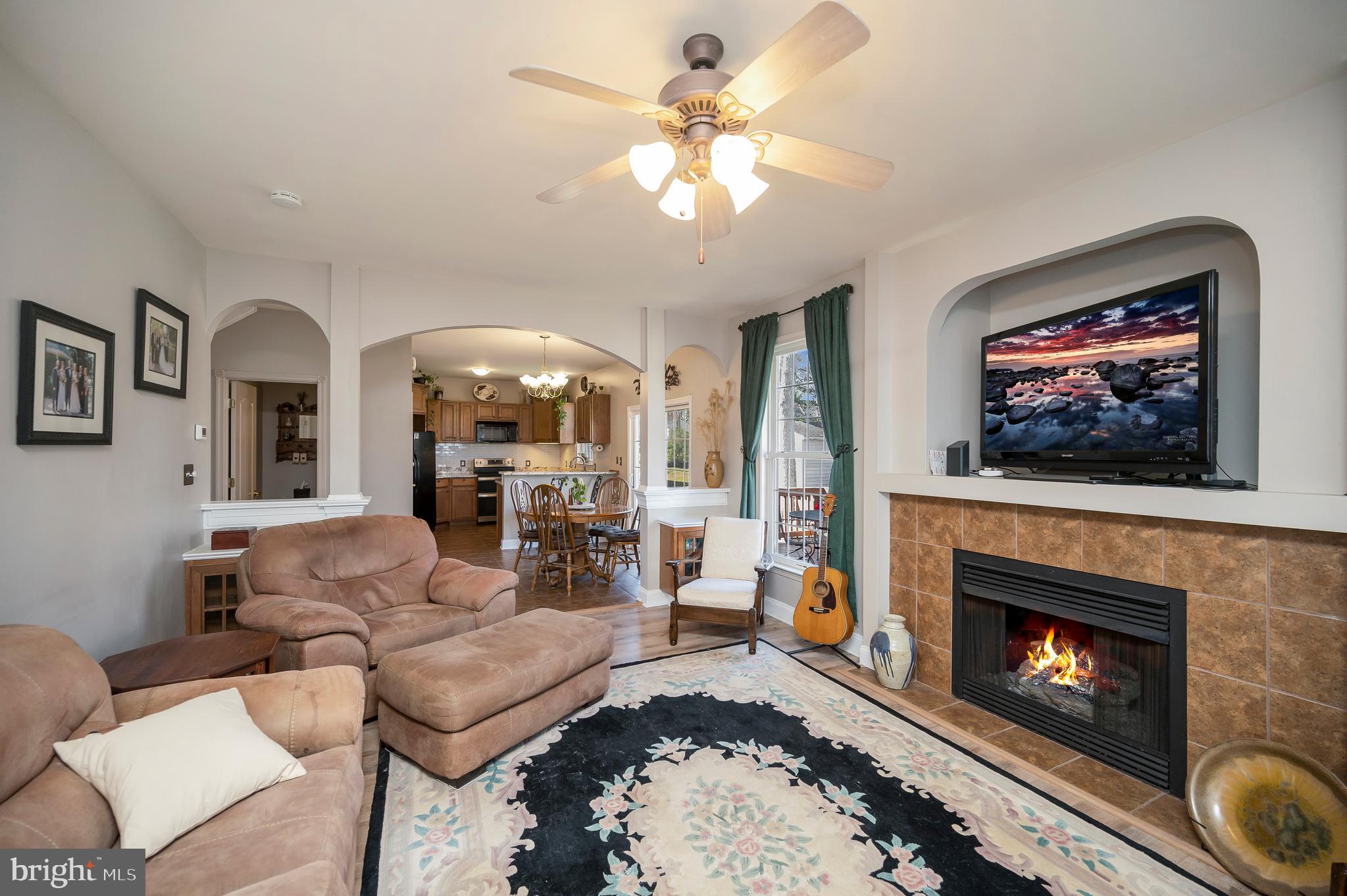 408 Liberty Boulevard Locust Grove, VA 22508 - Photo 11 of 45 a living room with furniture a fireplace and a flat screen tv