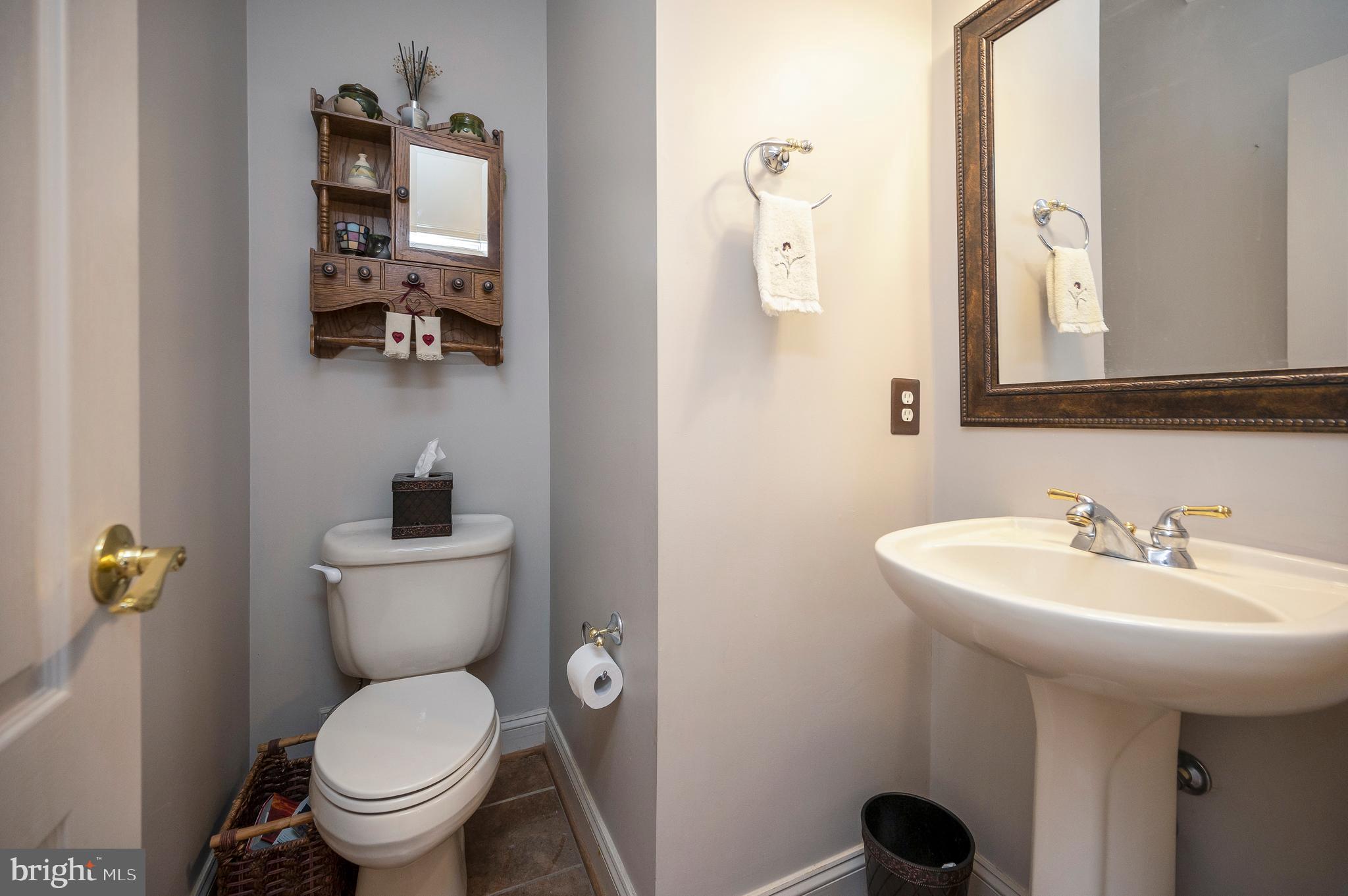 408 Liberty Boulevard Locust Grove, VA 22508 - Photo 13 of 45 a bathroom with a toilet sink and mirror