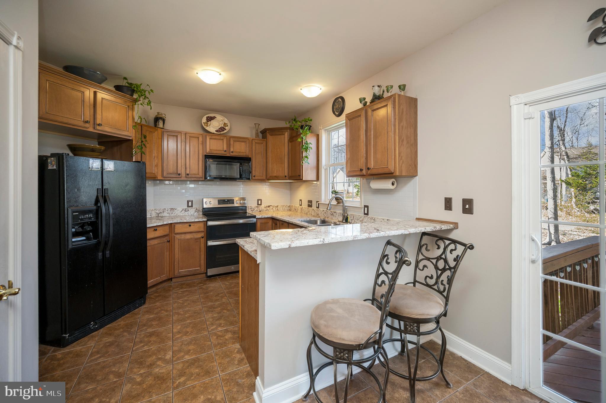 408 Liberty Boulevard Locust Grove, VA 22508 - Photo 7 of 45 a kitchen with stainless steel appliances a refrigerator sink and stove