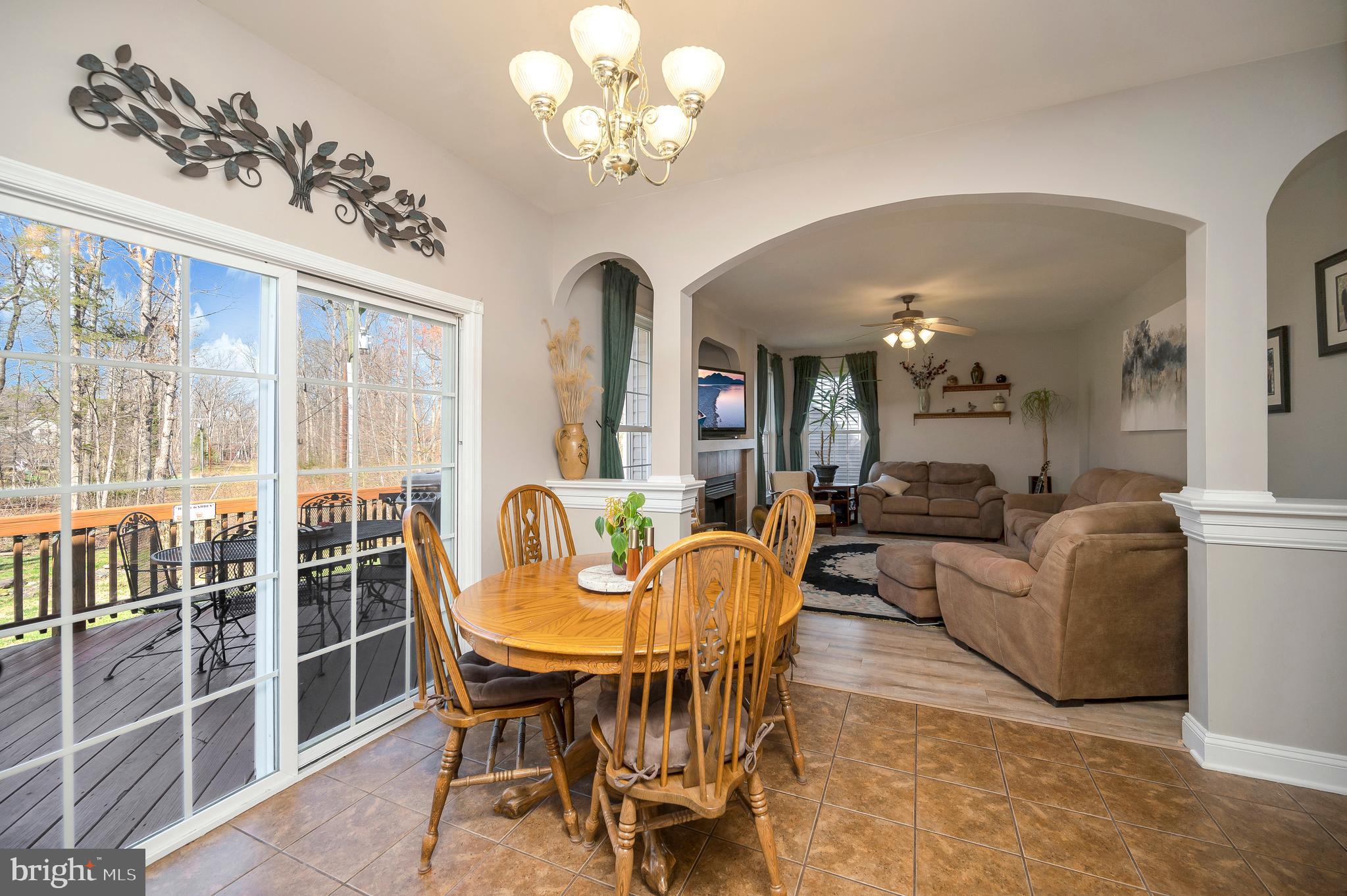 408 Liberty Boulevard Locust Grove, VA 22508 - Photo 9 of 45 a view of a dining room with furniture a chandelier and a window