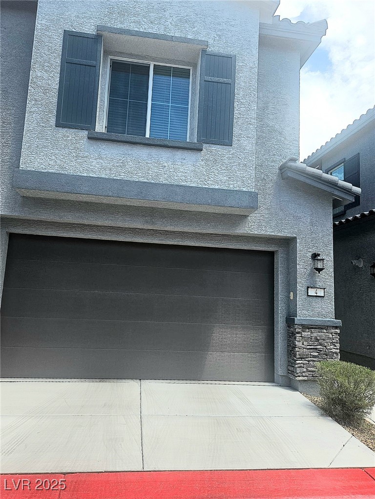 View of front of structure and garage