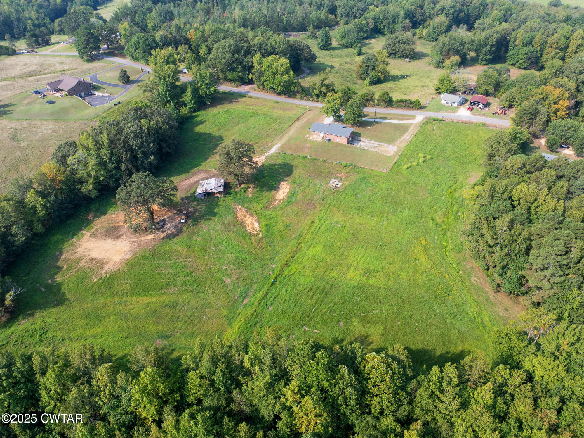 1176 Myracle Town Road Darden, TN 38328 - Photo 13 of 40 an aerial view of residential houses with outdoor space and trees