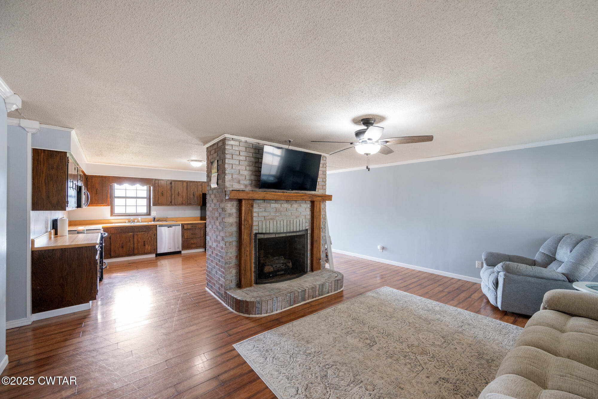 1176 Myracle Town Road Darden, TN 38328 - Photo 18 of 40 a living room with furniture a fireplace and a flat screen tv
