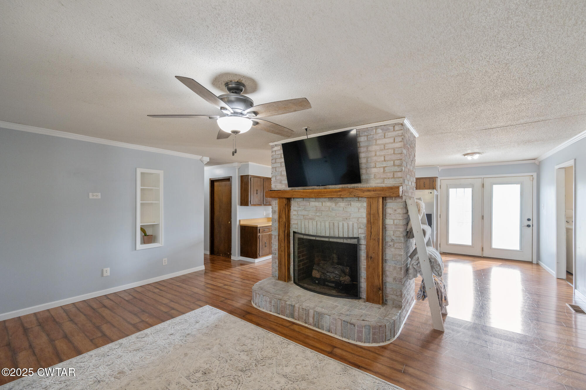 1176 Myracle Town Road Darden, TN 38328 - Photo 19 of 40 a living room with furniture a fireplace and a flat screen tv
