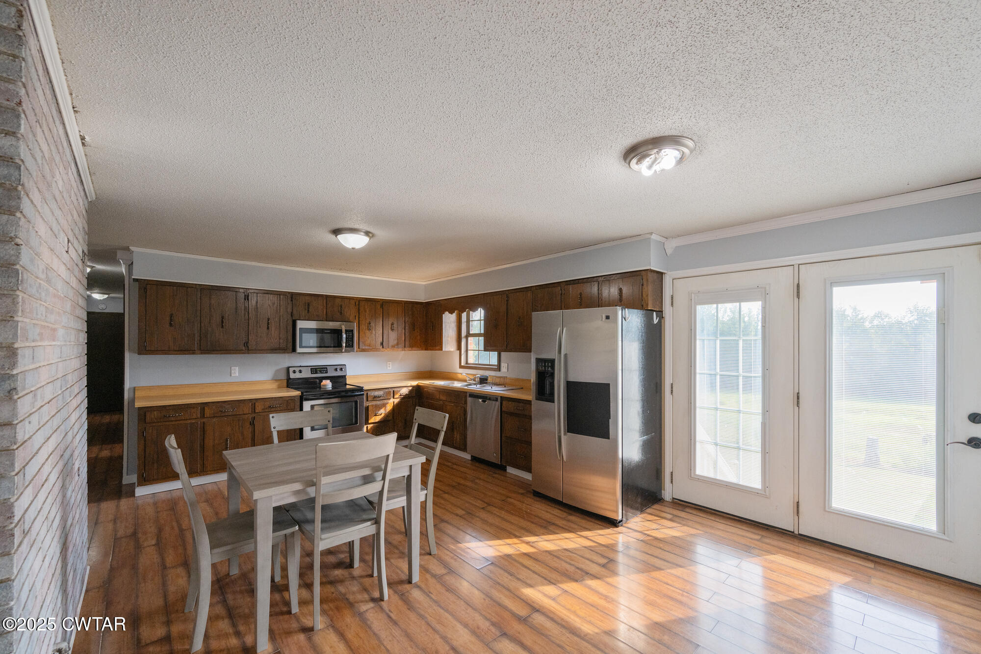 1176 Myracle Town Road Darden, TN 38328 - Photo 21 of 40 a kitchen with refrigerator and cabinets