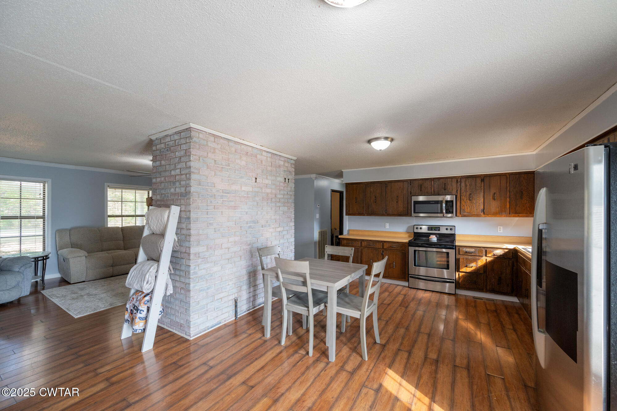 1176 Myracle Town Road Darden, TN 38328 - Photo 22 of 40 a living room with furniture a flat screen tv and wooden floor