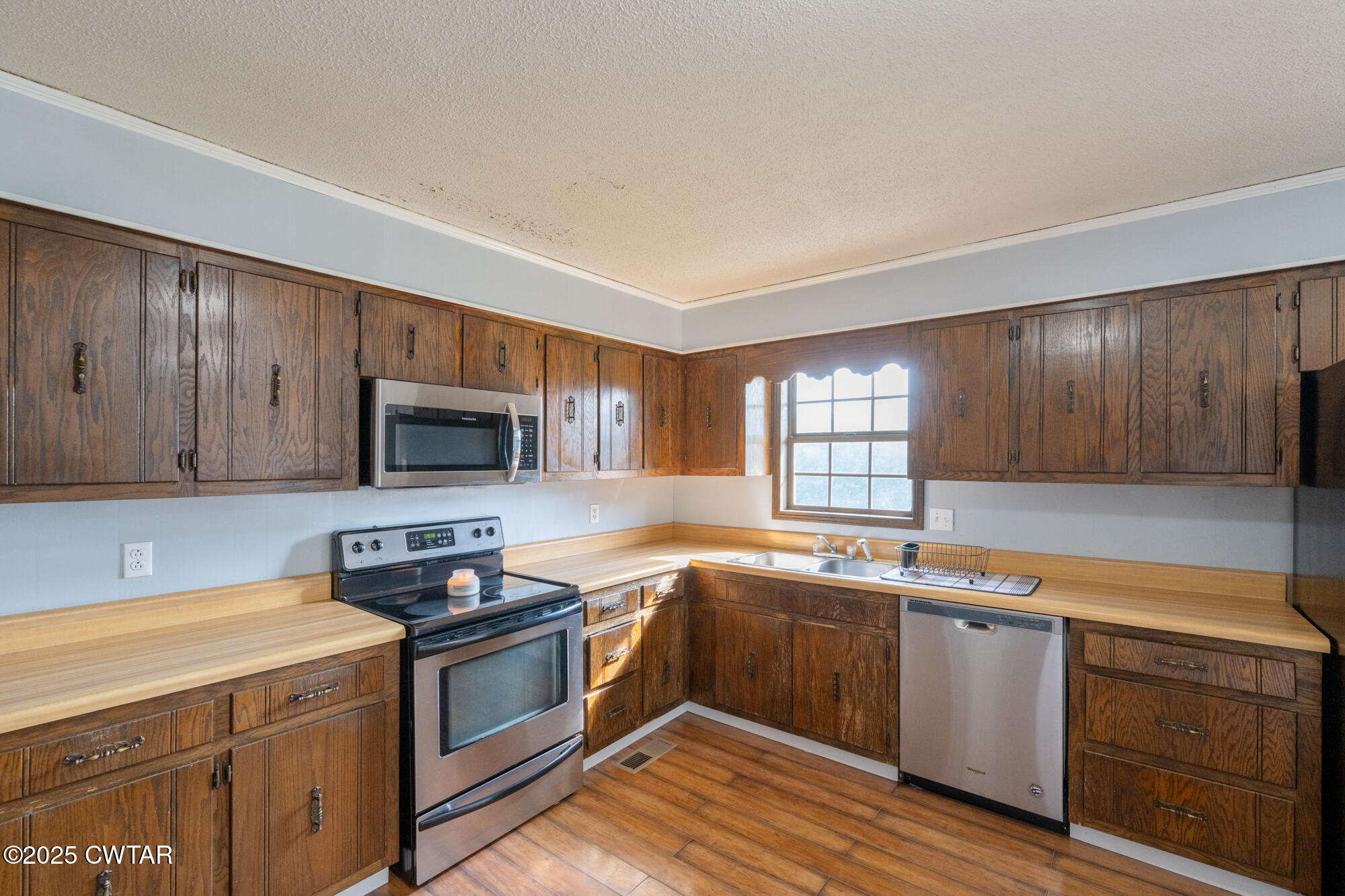 1176 Myracle Town Road Darden, TN 38328 - Photo 24 of 40 a kitchen with a sink stove top oven and cabinets