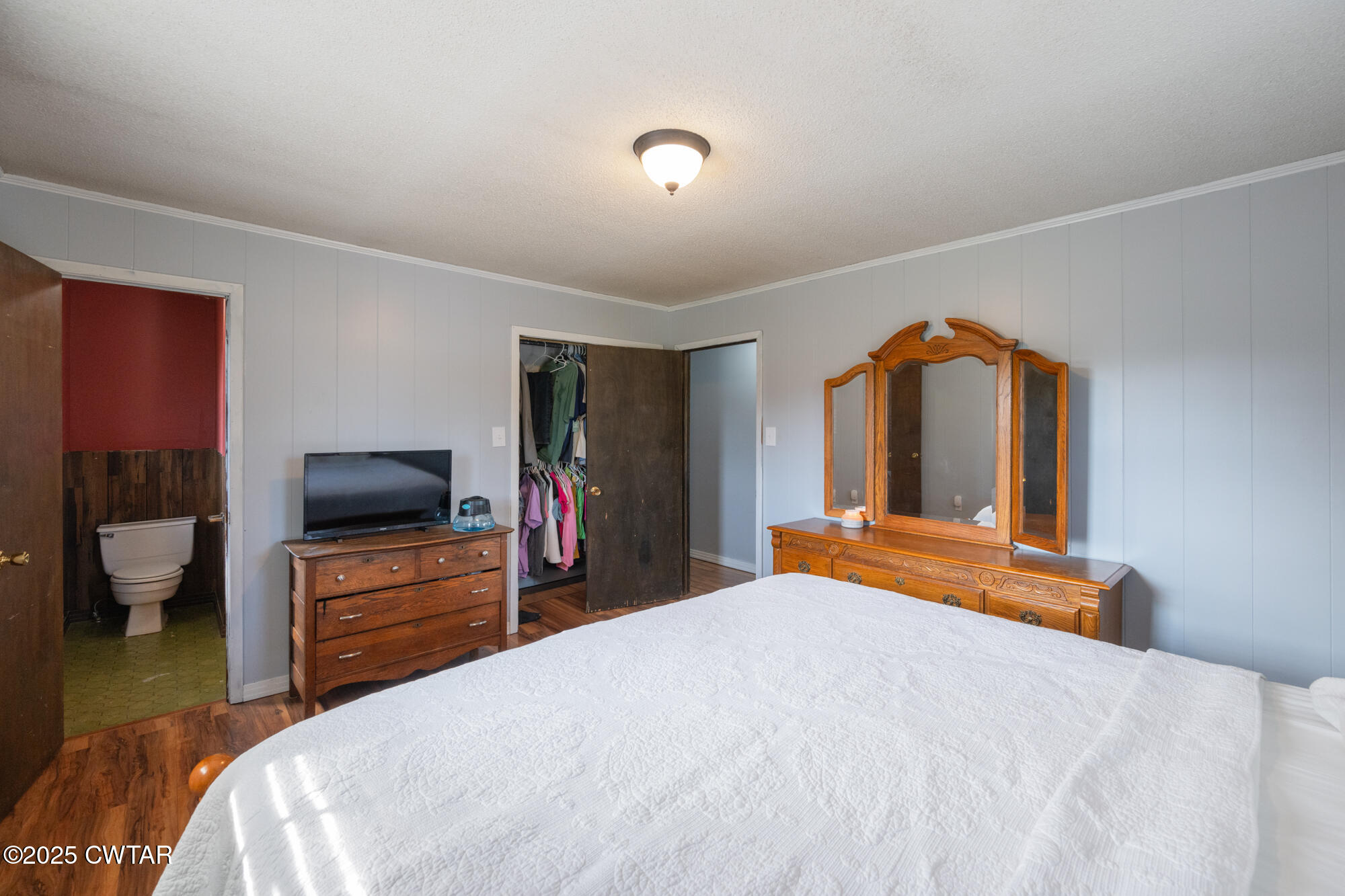1176 Myracle Town Road Darden, TN 38328 - Photo 30 of 40 a bedroom with a bed and a flat screen tv
