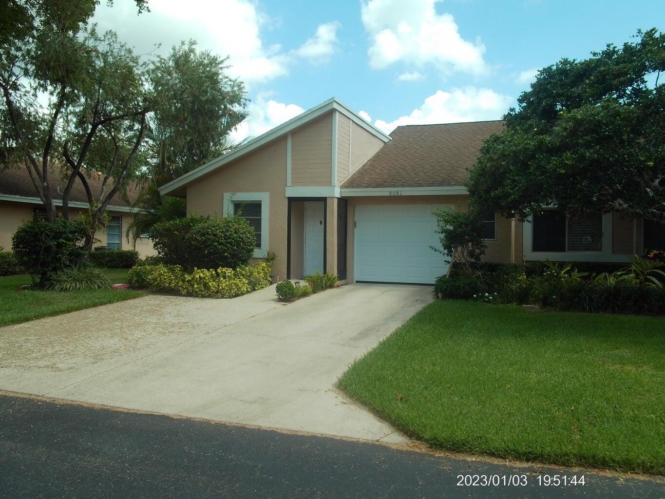 a view of a house with backyard and garden