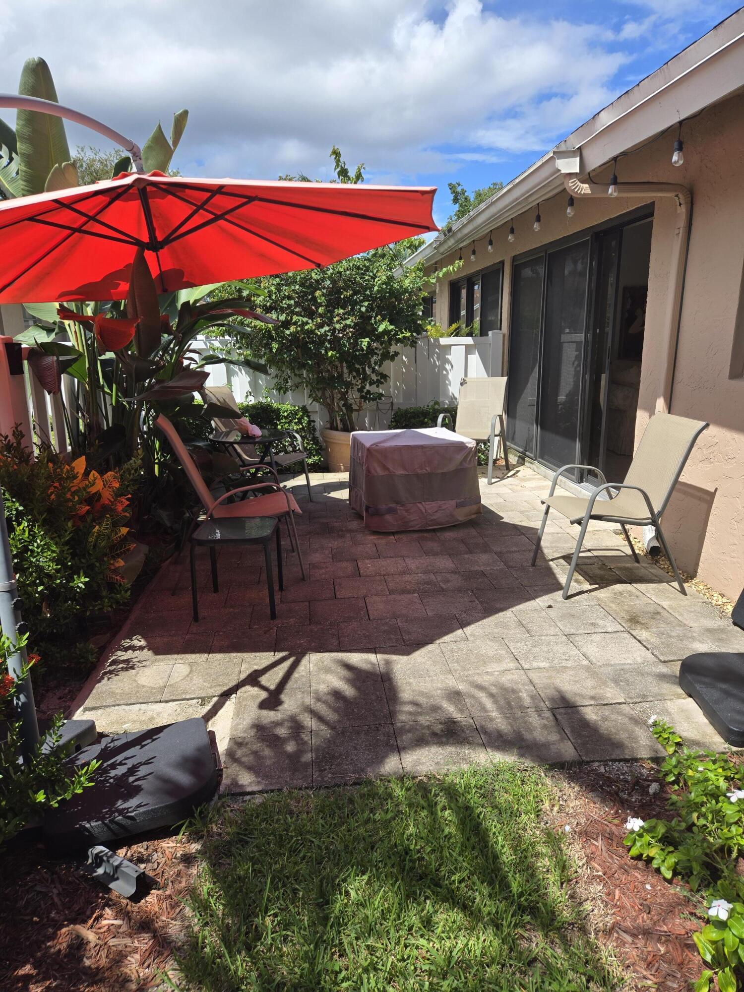 8081 Springtree Road, Unit C Boca Raton, FL 33496 - Photo 14 of 31 a view of a house with backyard and sitting area