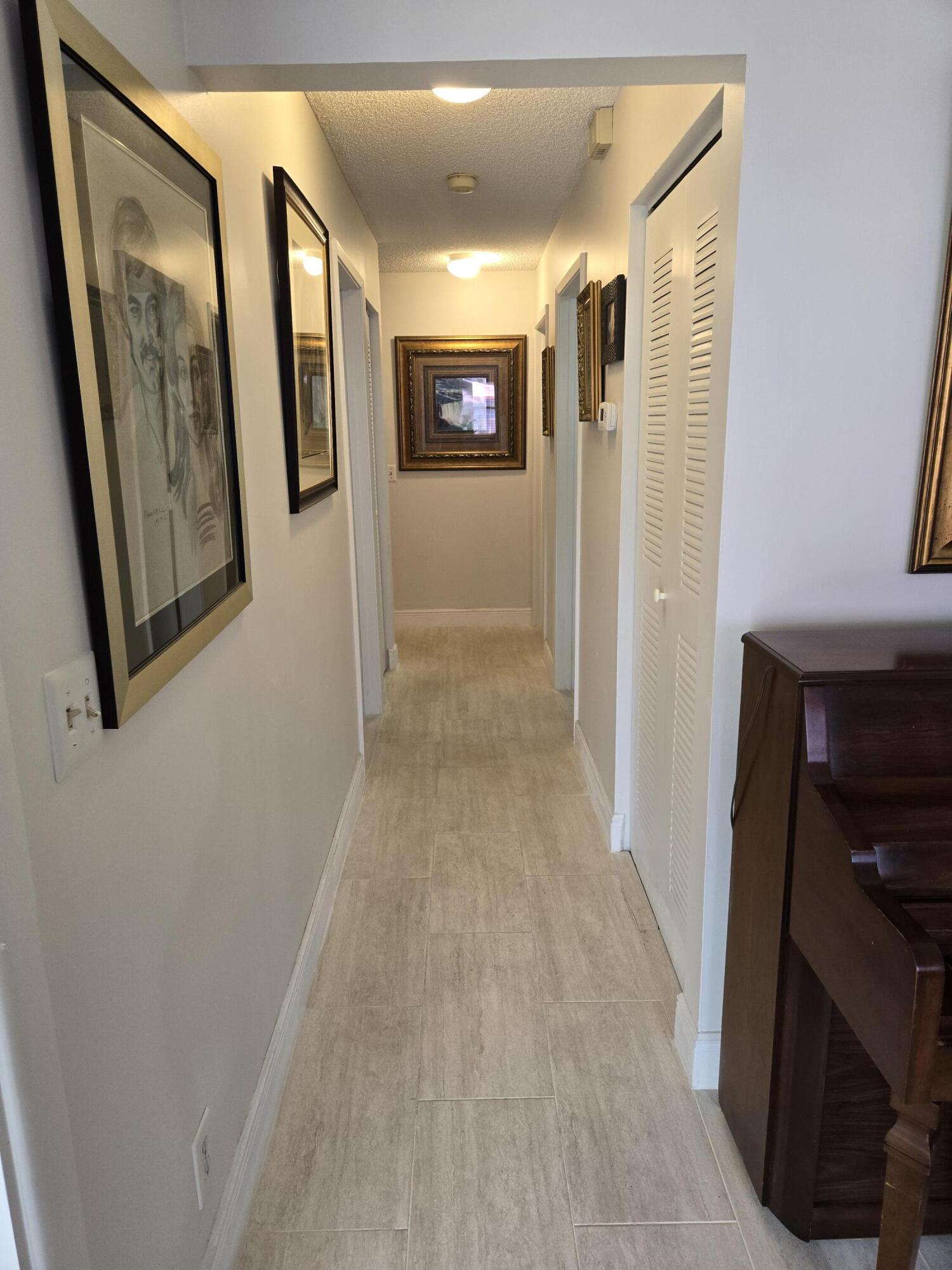 8081 Springtree Road, Unit C Boca Raton, FL 33496 - Photo 15 of 31 a view of a hallway with wooden floor and windows