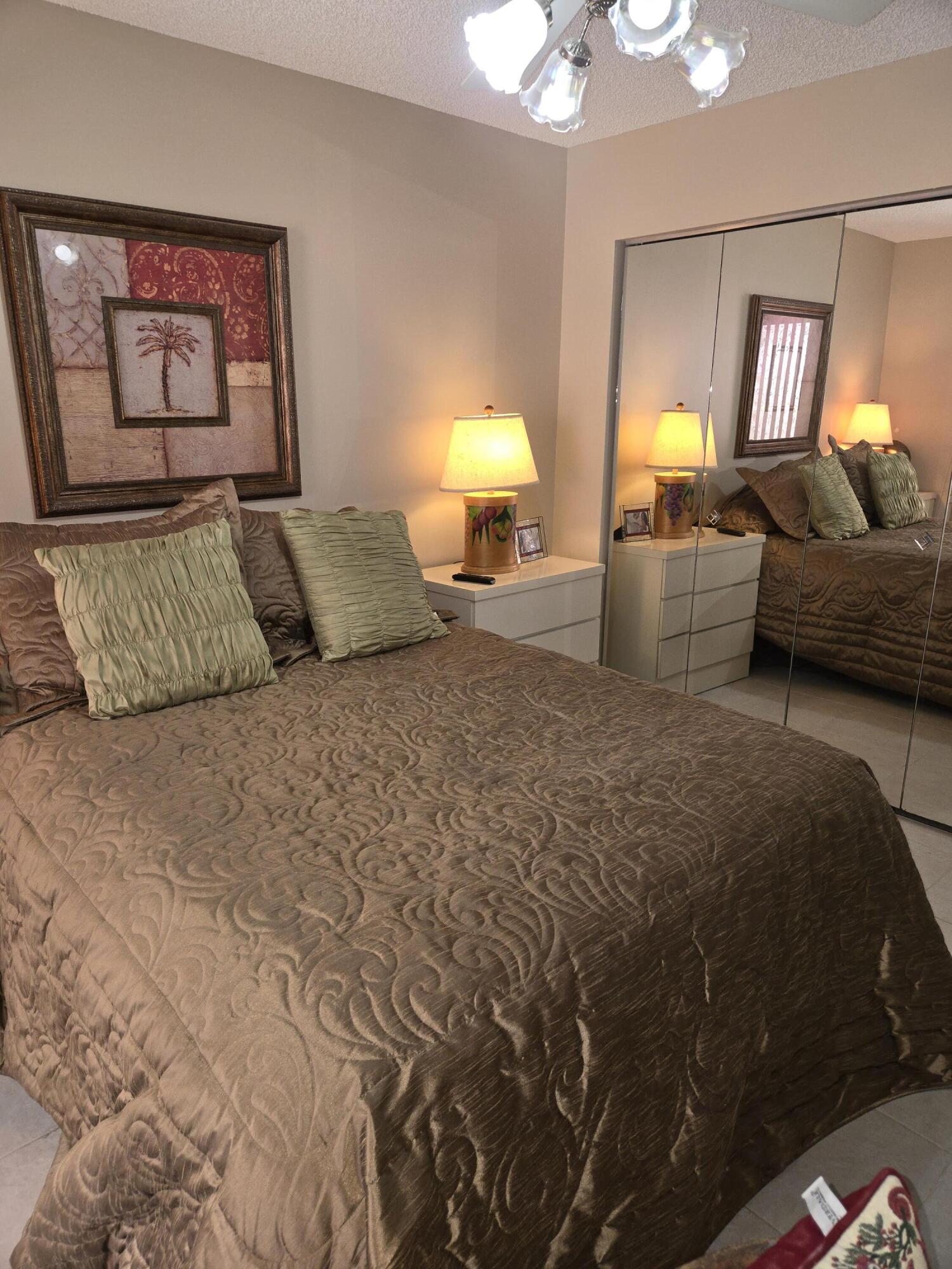 8081 Springtree Road, Unit C Boca Raton, FL 33496 - Photo 17 of 31 a bedroom with a bed and window