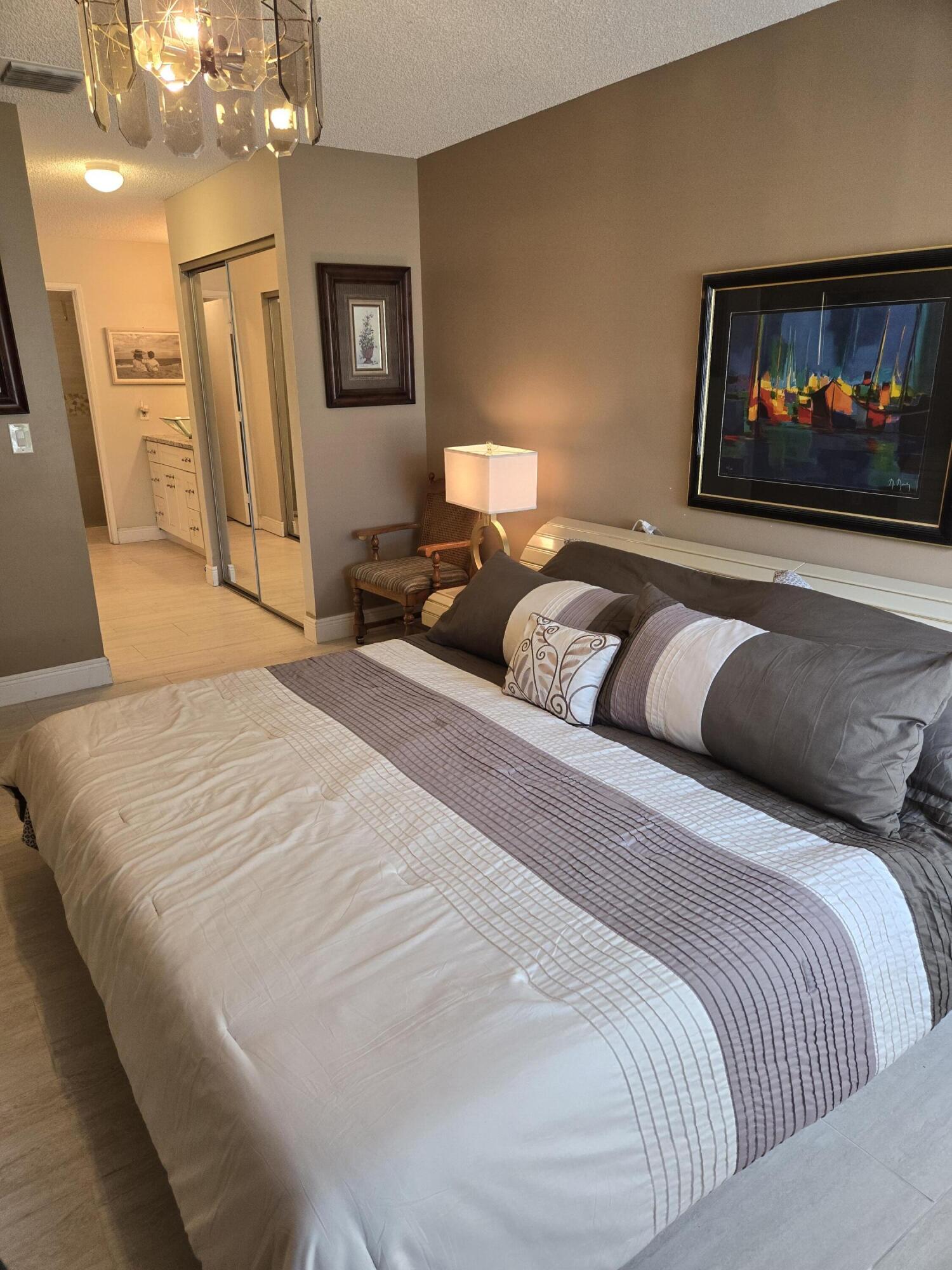 8081 Springtree Road, Unit C Boca Raton, FL 33496 - Photo 21 of 31 a bedroom with a bed and a couch