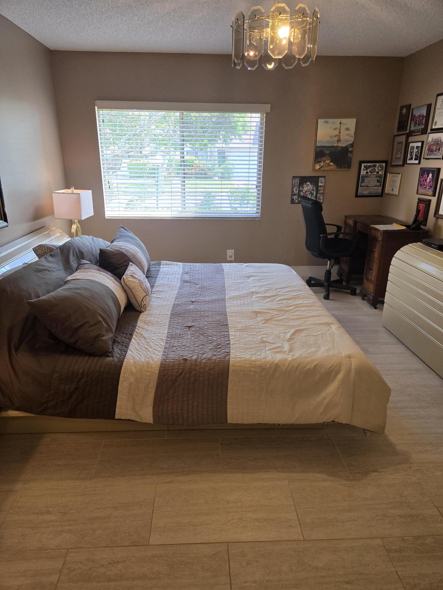 8081 Springtree Road, Unit C Boca Raton, FL 33496 - Photo 22 of 31 a bedroom with a bed and window