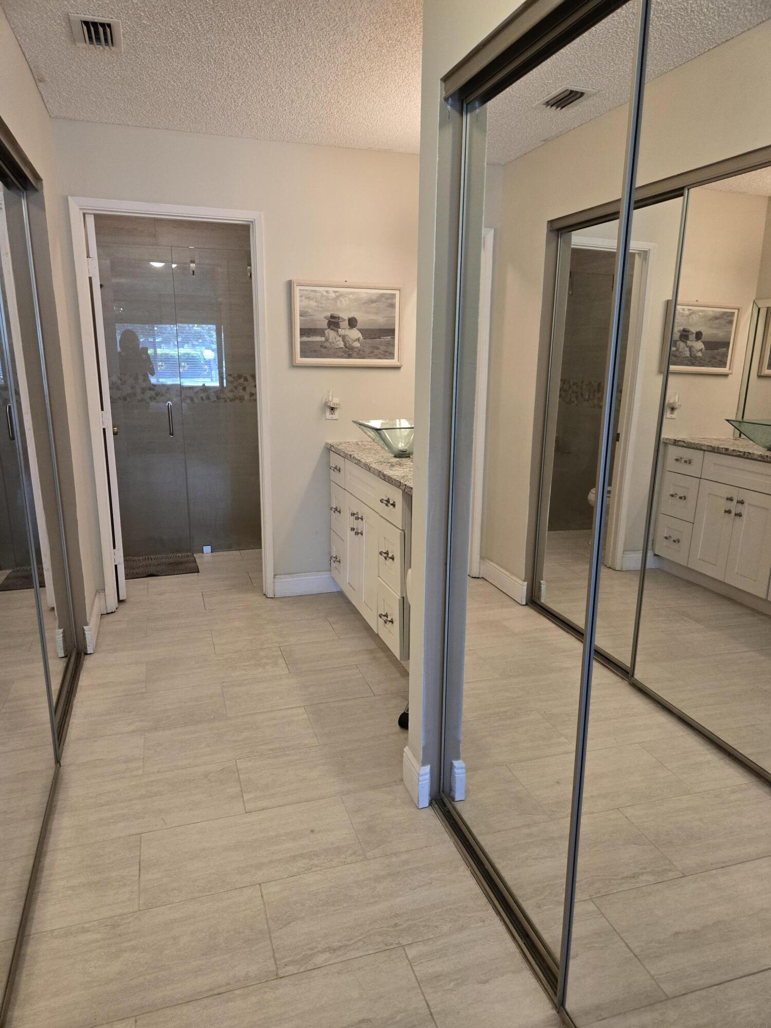 8081 Springtree Road, Unit C Boca Raton, FL 33496 - Photo 23 of 31 a bathroom with a shower and a sink