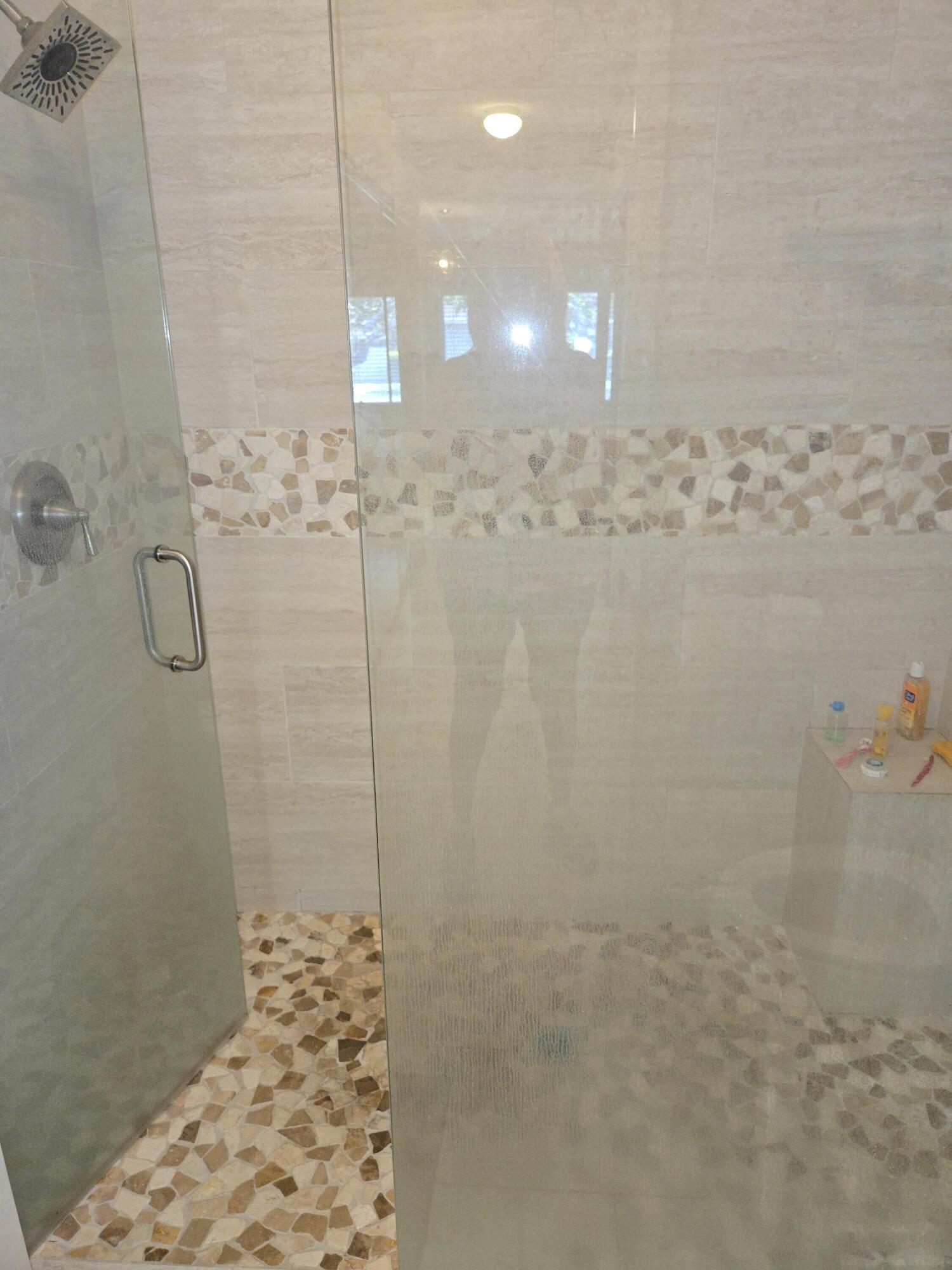 8081 Springtree Road, Unit C Boca Raton, FL 33496 - Photo 25 of 31 a bathroom with a shower