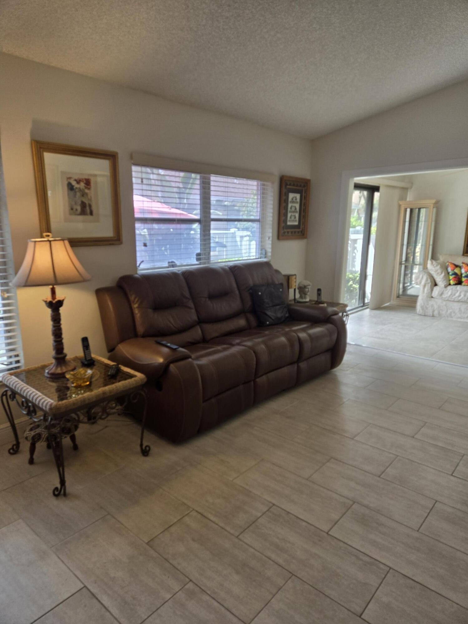 8081 Springtree Road, Unit C Boca Raton, FL 33496 - Photo 4 of 31 a living room with furniture and a window