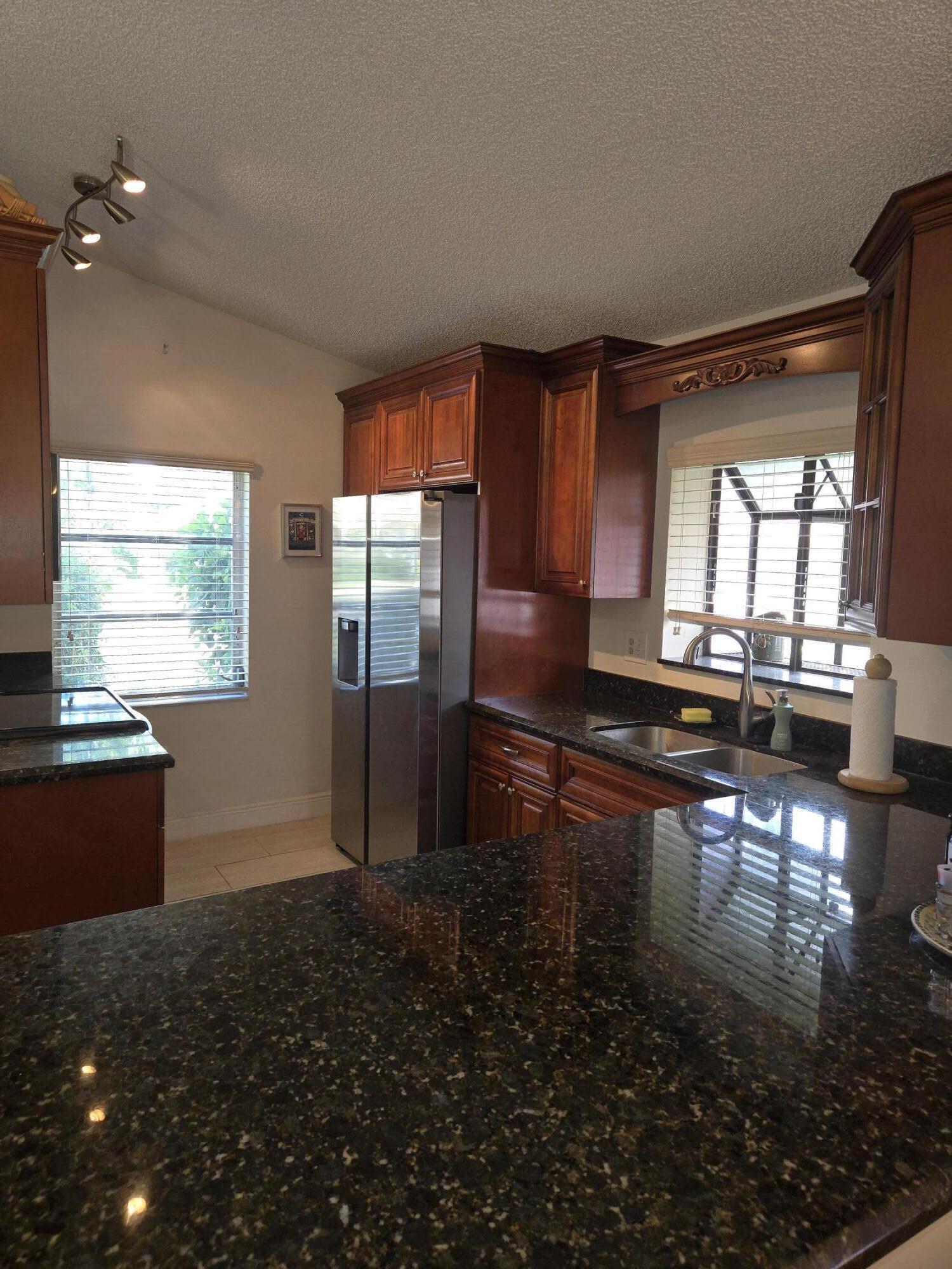 8081 Springtree Road, Unit C Boca Raton, FL 33496 - Photo 8 of 31 a kitchen with granite countertop lots of counter top space