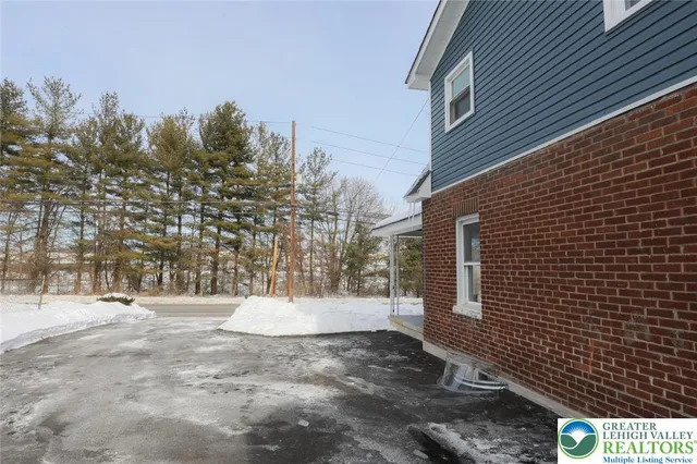 a view of a hallway with wooden floor and entryway