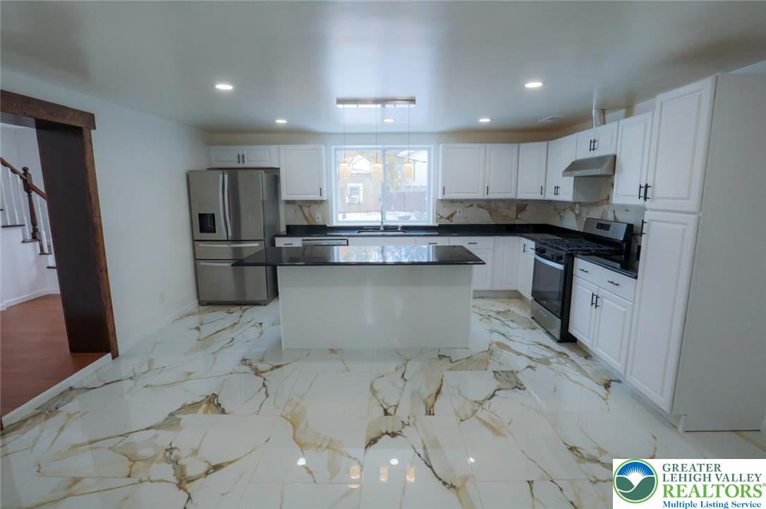 2270 Easton Road Bethlehem, PA 18015 - Photo 3 of 43 a kitchen with stainless steel appliances a sink a stove a refrigerator cabinets and a dining table