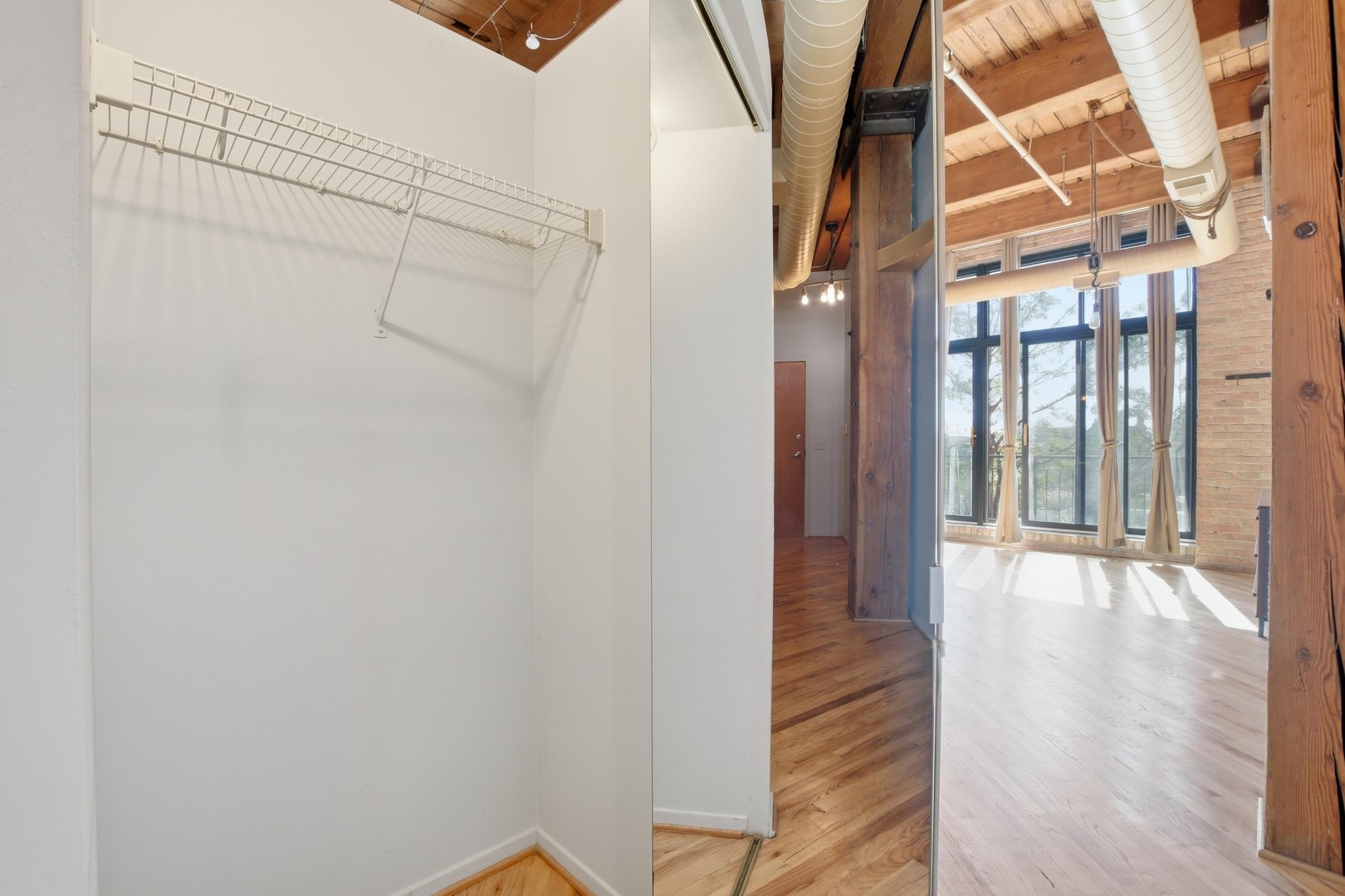 1250 West Van Buren Street, Unit 313 Chicago, IL 60607 - Photo 11 of 16 a view of an entryway with wooden floor